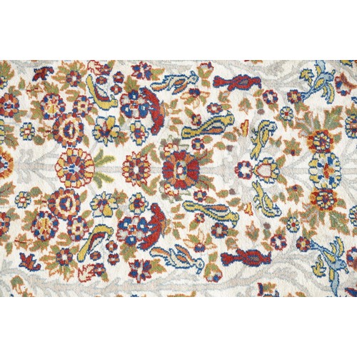 692 - Middle Eastern carpet rug having a white arched panel to centre decorated with florals and fauna wit... 