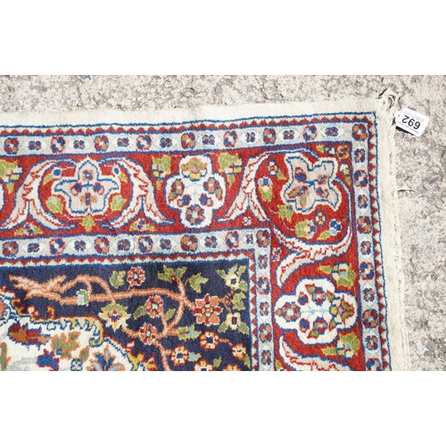 692 - Middle Eastern carpet rug having a white arched panel to centre decorated with florals and fauna wit... 