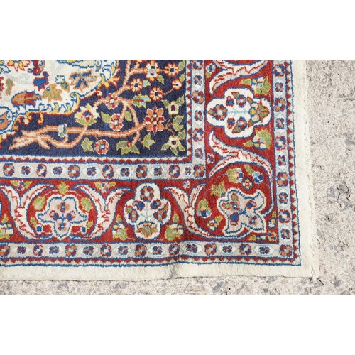 692 - Middle Eastern carpet rug having a white arched panel to centre decorated with florals and fauna wit... 