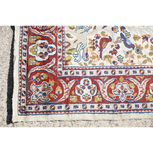 692 - Middle Eastern carpet rug having a white arched panel to centre decorated with florals and fauna wit... 