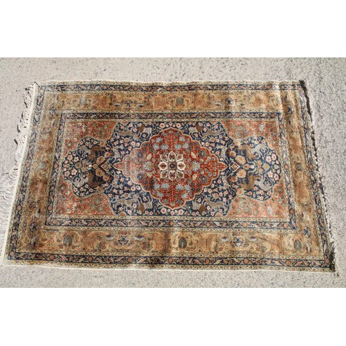 695 - Middle Eastern carpet rug having a central medallion red medallion within a blue flora and fauna dec... 