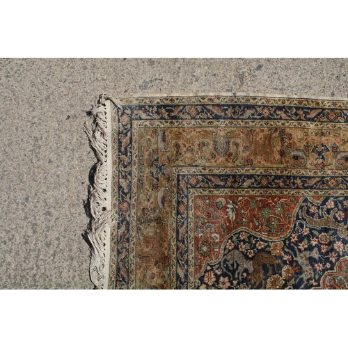 695 - Middle Eastern carpet rug having a central medallion red medallion within a blue flora and fauna dec... 