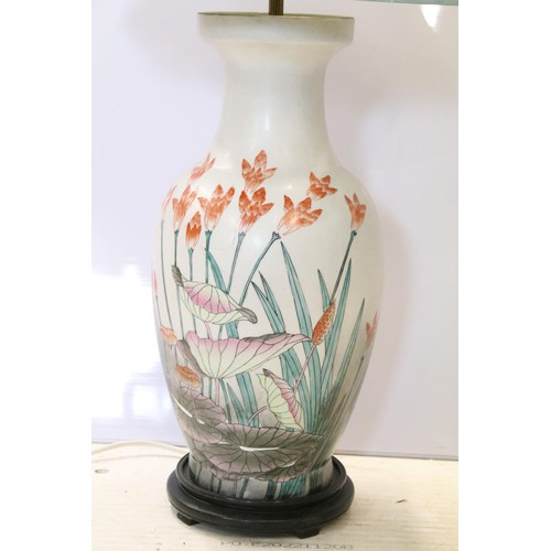 87A - 20th Century Chinese vase lamp base having a white ground with lotus leaves and florals raised on a ... 