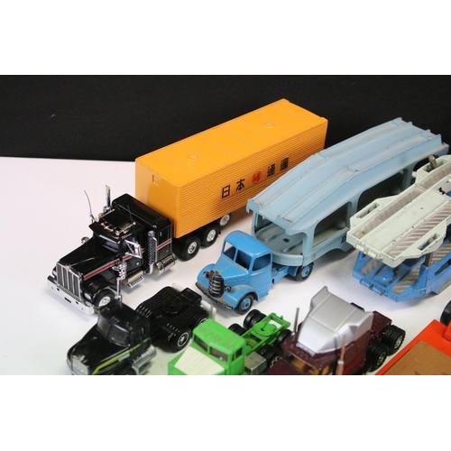 1303 - 24 Play worn commercial diecast models, mainly from the mid 20th C to include Dinky Car Transporter,... 