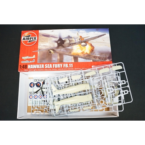 306 - Four boxed plastic model kits to include 1/48 Airfix Hawker Sea Fury FB.11 (appearing complete, part... 