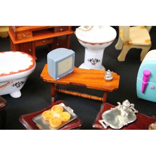 437 - Collection of various dolls house furniture to include dresser, chairs, sofa, table and cutlery, cer... 