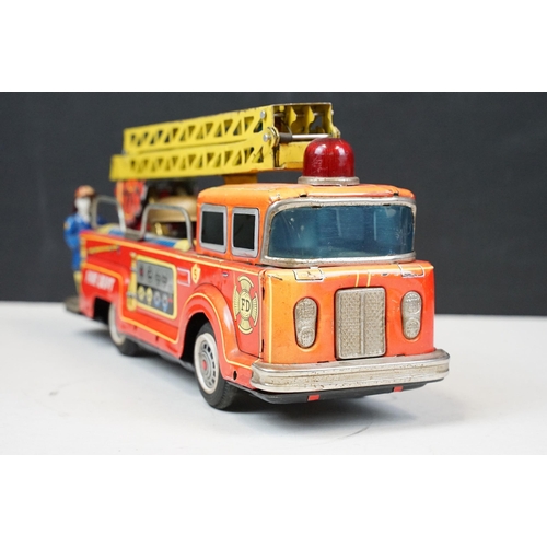 415 - Two fire engine models to include boxed tin plate ME 699 Battery Operated Fire Chief and tin plate f... 