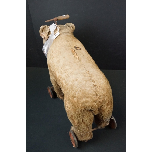 443 - Early-mid 20th C pull along bear, unmarked but in the Steiff style, with hump to shoulders, straw fi... 