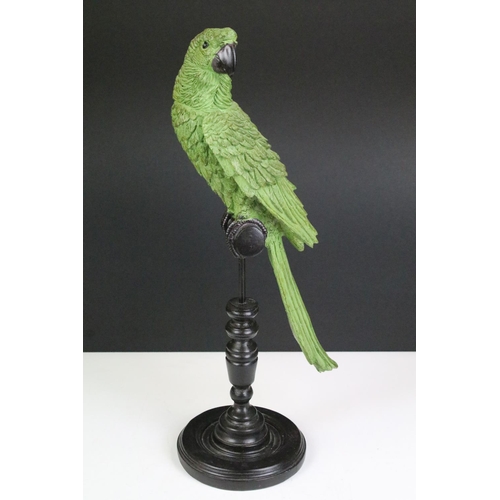 135 - Model of a green parrot on a perch mounted on a turned wooden base, 43cm high