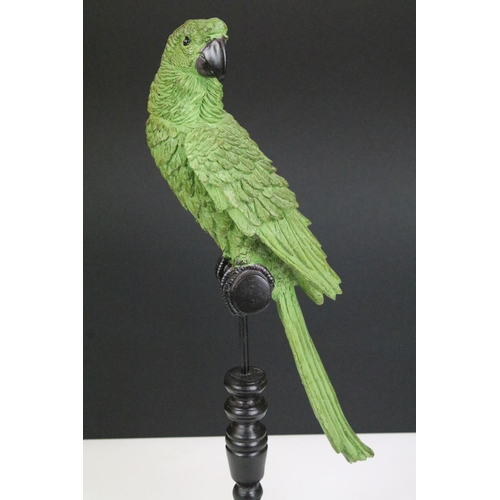 135 - Model of a green parrot on a perch mounted on a turned wooden base, 43cm high