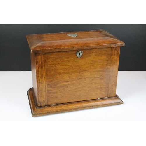 146 - Early 20th century oak stationery box with key, the fall front revealing carved sections, with three... 