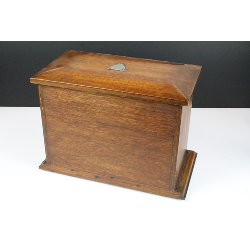 146 - Early 20th century oak stationery box with key, the fall front revealing carved sections, with three... 