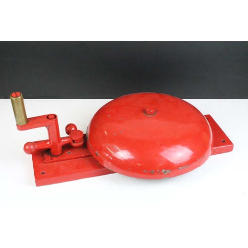 149 - Vintage red crank handled fire bell having a large bell to centre with handle and strike to top. Mea... 