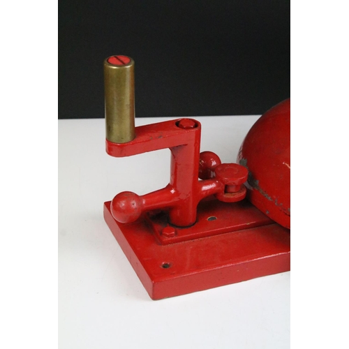 149 - Vintage red crank handled fire bell having a large bell to centre with handle and strike to top. Mea... 