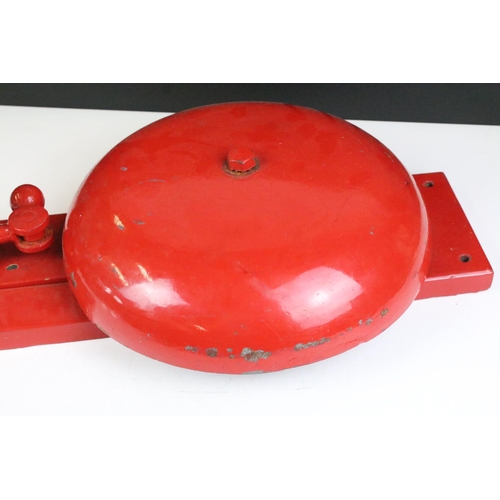 149 - Vintage red crank handled fire bell having a large bell to centre with handle and strike to top. Mea... 