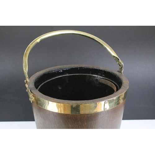 154 - Edwardian oak coal bucket with brass banding together with a hammered brass example. Bucket measures... 