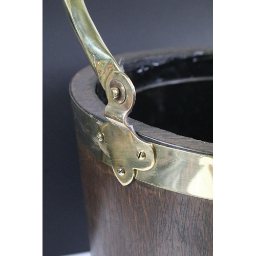 154 - Edwardian oak coal bucket with brass banding together with a hammered brass example. Bucket measures... 