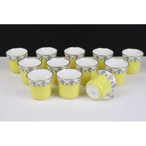 114 - Royal Stafford yellow ground floral china tea set, marked 4895, to include 12 cups & saucers, 12 tea... 