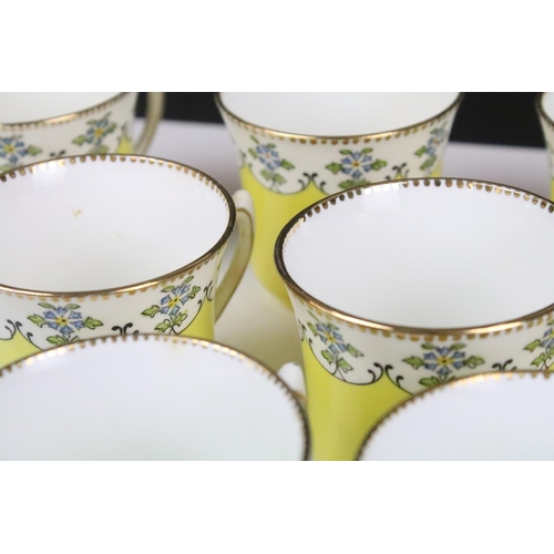 114 - Royal Stafford yellow ground floral china tea set, marked 4895, to include 12 cups & saucers, 12 tea... 