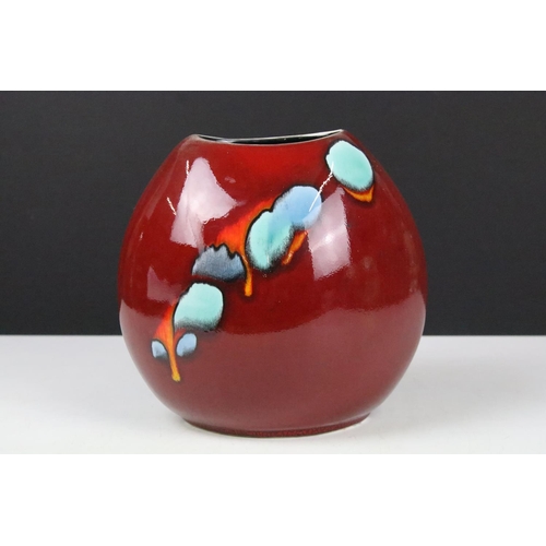 45A - Poole pottery living glaze pattern vase having a red ground with blue detailing. Measures 18cm tall.