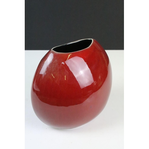 45A - Poole pottery living glaze pattern vase having a red ground with blue detailing. Measures 18cm tall.