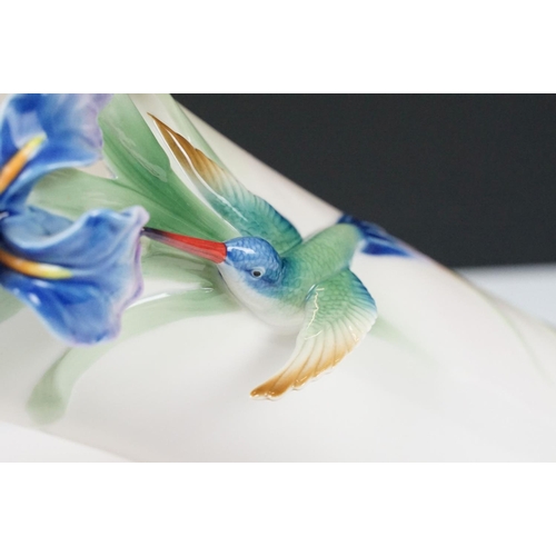 12 - Franz porcelain vase moulded in relief with blue orchids and a Hummingbird, numbered FZ01203, approx... 