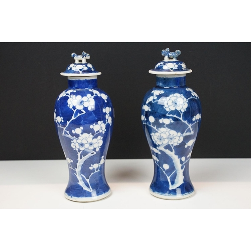 13 - Pair of Chinese porcelain blue and white baluster vases and covers, decorated with prunus blossom, b... 