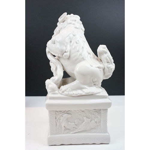 23 - Pair of Chinese white ceramic mythical lions (approx 33cm tall), together with a Guan Yin ceramic fi... 