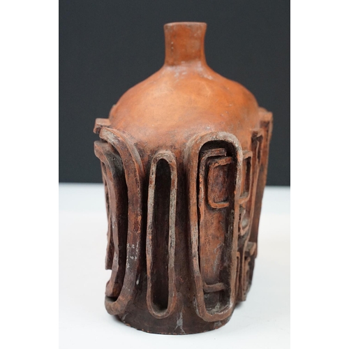 26 - Unusual clay vase of compressed bottle form, with relief spiralling decoration, approx 19cm tall