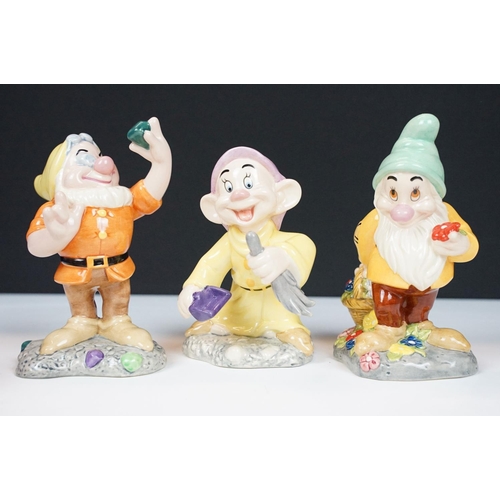 44 - Collection of 11 Royal Doulton Disney Snow White porcelain figures to include Snow White (DP 5), Doc... 