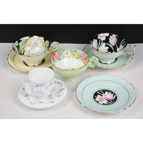 58 - Two Paragon floral teacups & saucers with black ground floral decoration, to include a blue and yell... 