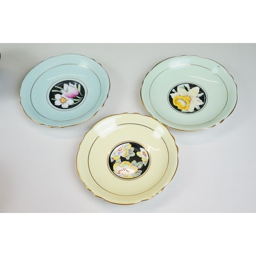 58 - Two Paragon floral teacups & saucers with black ground floral decoration, to include a blue and yell... 