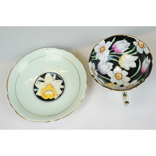 58 - Two Paragon floral teacups & saucers with black ground floral decoration, to include a blue and yell... 