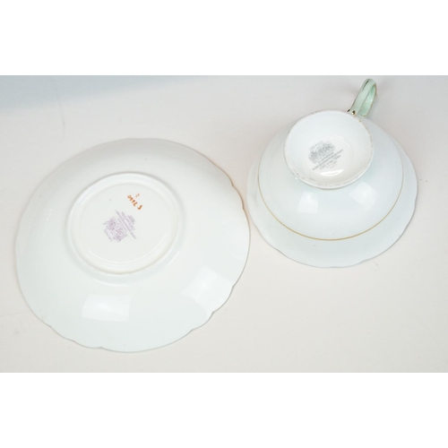 58 - Two Paragon floral teacups & saucers with black ground floral decoration, to include a blue and yell... 