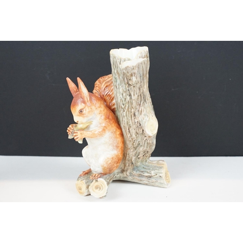 72 - Royal Worcester porcelain figure of a red squirrel modelled seated by a tree stump eating a nut, imp... 