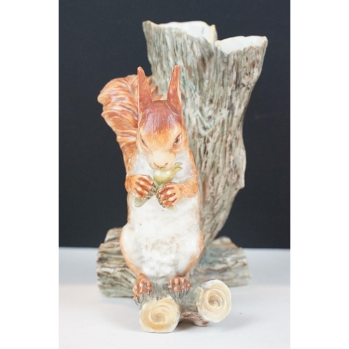 72 - Royal Worcester porcelain figure of a red squirrel modelled seated by a tree stump eating a nut, imp... 