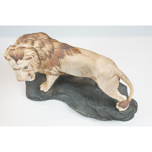 74 - Two matt glaze Beswick figurines of a lion and a mountain cat (numbered 1702, approx 20.5cm tall)