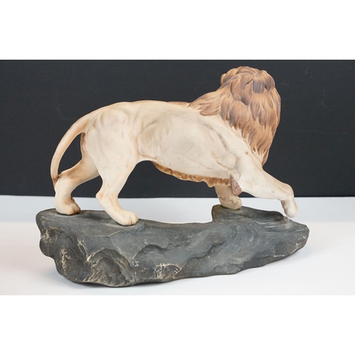 74 - Two matt glaze Beswick figurines of a lion and a mountain cat (numbered 1702, approx 20.5cm tall)