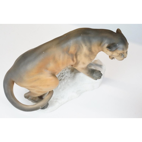 74 - Two matt glaze Beswick figurines of a lion and a mountain cat (numbered 1702, approx 20.5cm tall)