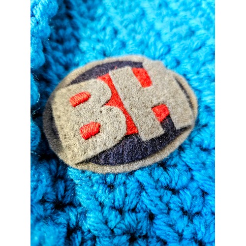 73 - A miniature blue Bargain Hunt jacket (approx. for a one year old) hand-crocheted and appliquéd by Ba... 