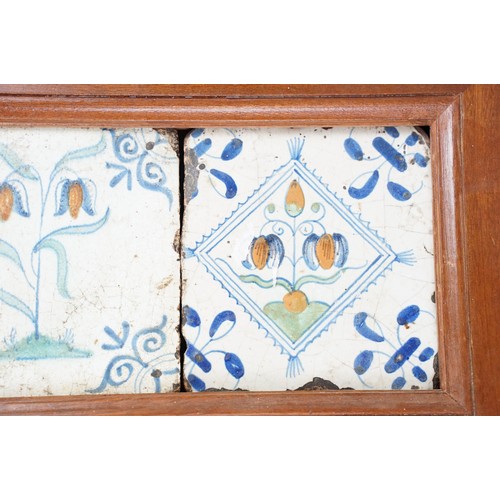 45 - Dutch delft tiles, 18th century, the central tile polychrome decorated with tulips, flanked by two f... 