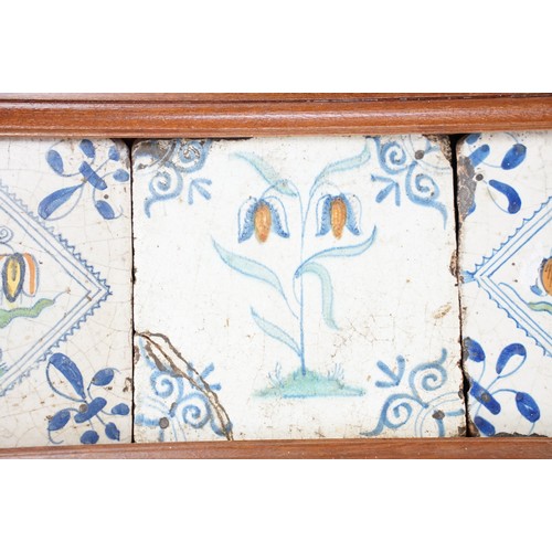 45 - Dutch delft tiles, 18th century, the central tile polychrome decorated with tulips, flanked by two f... 