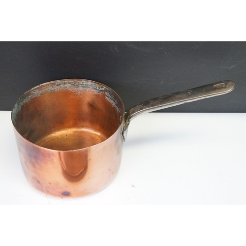 111 - Graduating set of six copper saucepans with brass handled, together with a larger saucepan & cover (... 