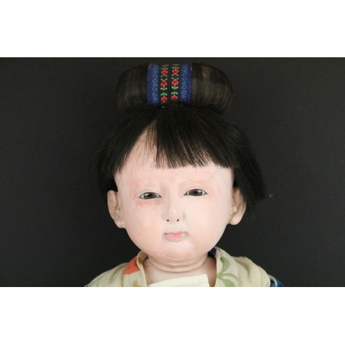 113A - A large Japanese articulated doll in traditional dress, stands approx 60cm in height