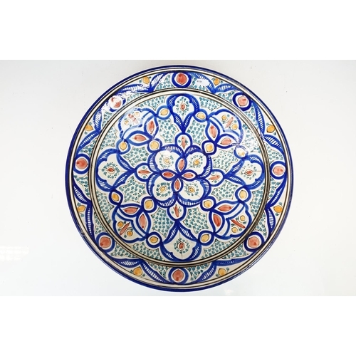 128 - Large glazed terracotta circular dish, possibly Morrocan, with repeating design and cobalt blue rim,... 