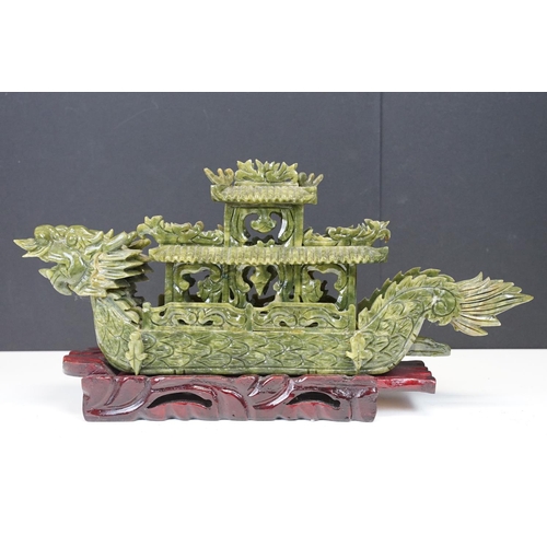 129 - Chinese carved jade dragon boat raised on a hardwood stand, approx 39cm long