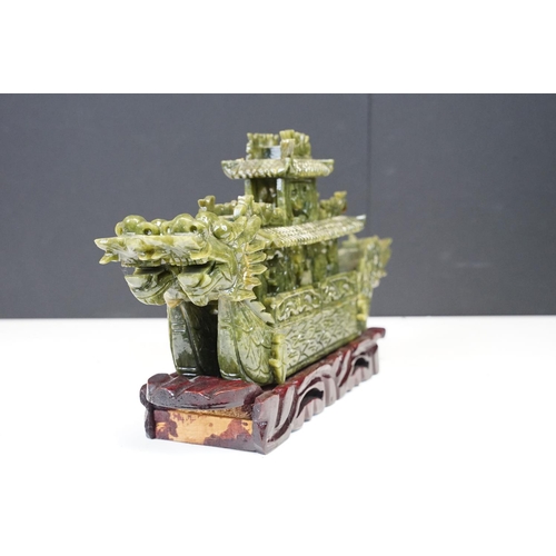 129 - Chinese carved jade dragon boat raised on a hardwood stand, approx 39cm long