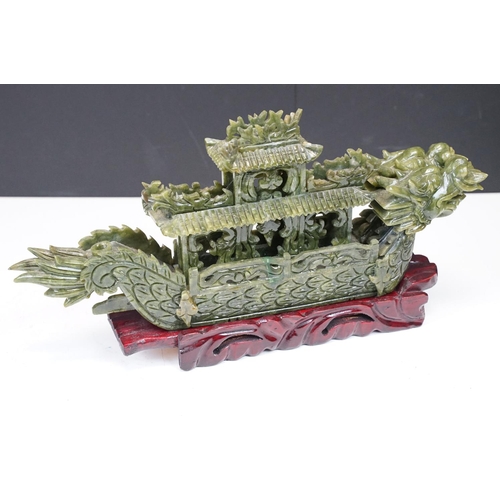 129 - Chinese carved jade dragon boat raised on a hardwood stand, approx 39cm long