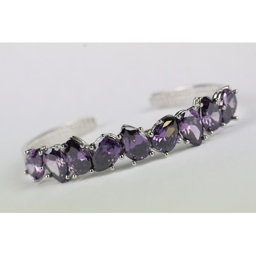 154 - A 925 sterling silver open cuff bangle set with nine tear drop amethyst stones, marked 925 to the ve... 