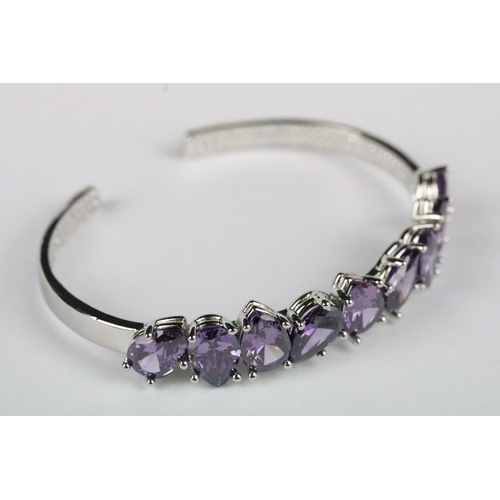 154 - A 925 sterling silver open cuff bangle set with nine tear drop amethyst stones, marked 925 to the ve... 